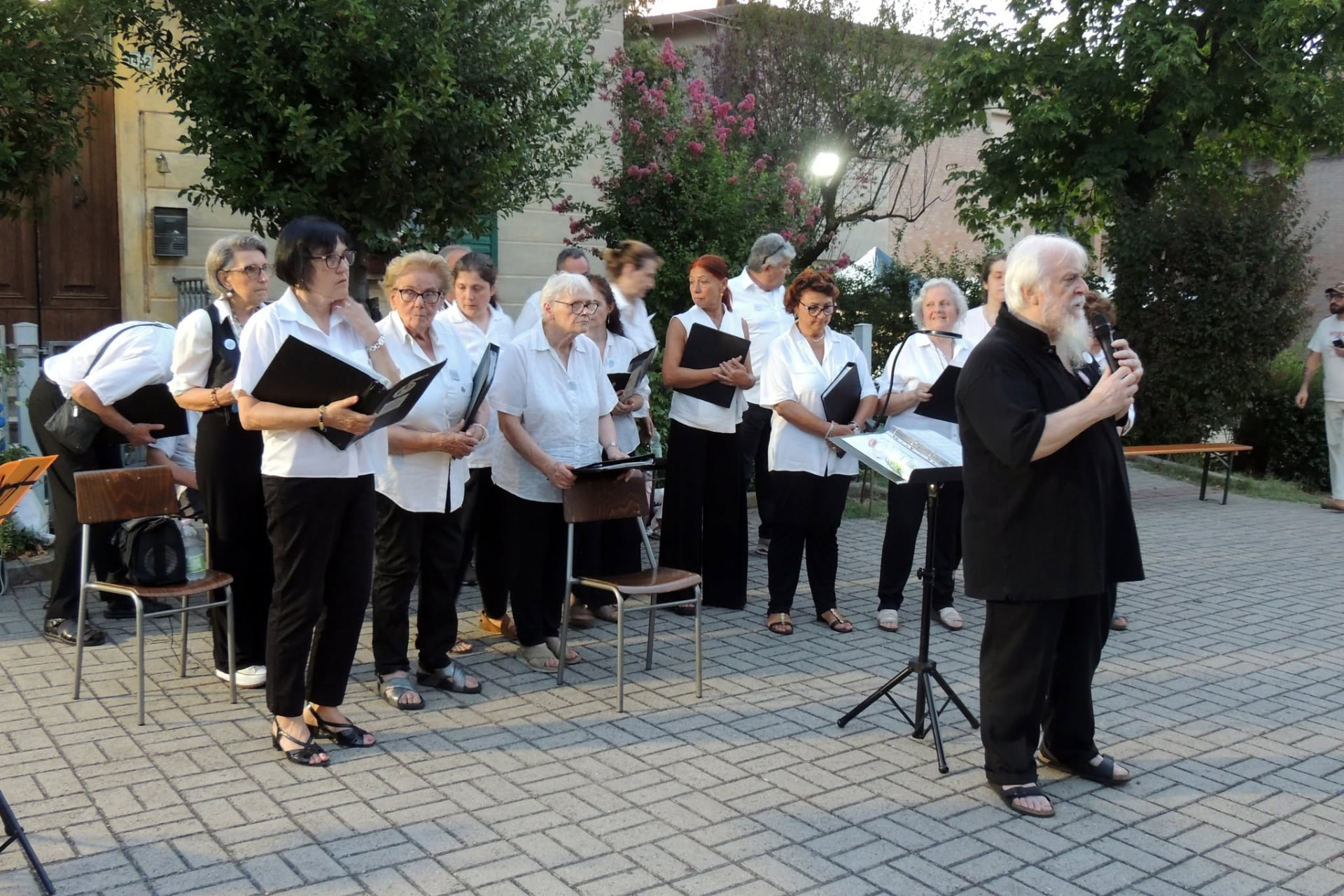 Il maestro parla al pubblico con il microfono prima del concerto